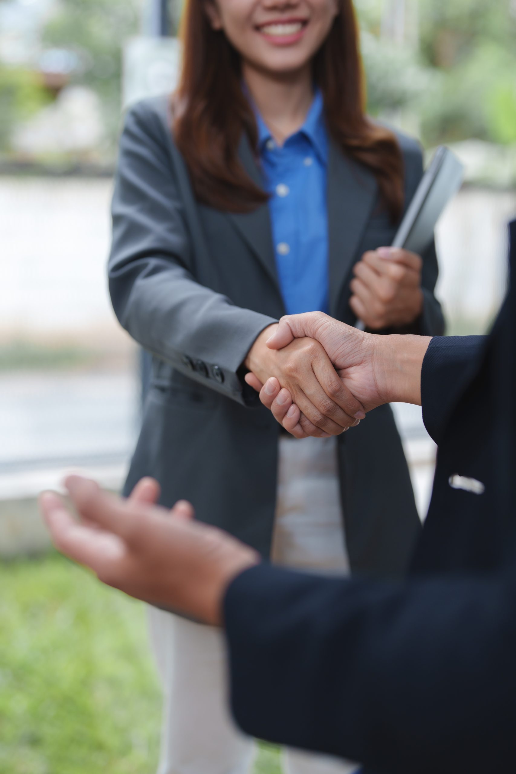 Businesswomen shaking hands after successful meeting in office